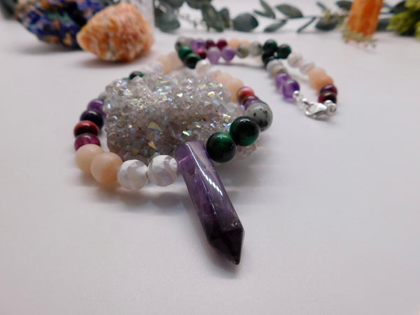 Rainbow gemstone necklace with Amethyst crystal point as pendant.